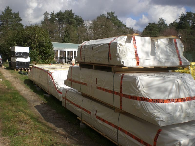 A log cabin generally arrives in packages such as these and are protected from the elements