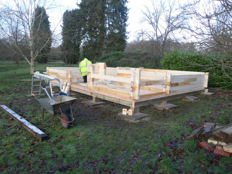 Building the Edelweiss log cabin on the stilt timber base