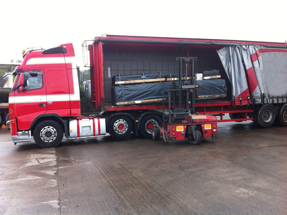 Log cabin deliveries take place with an articulated lorry and a demountable forklift.