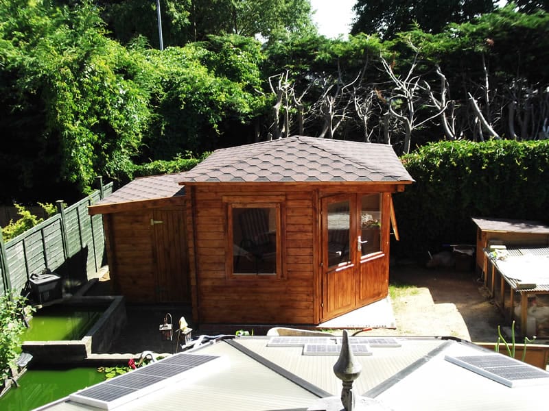 The Asmund corner log cabin with a shed extension log cabin accessory to the rear of the build.