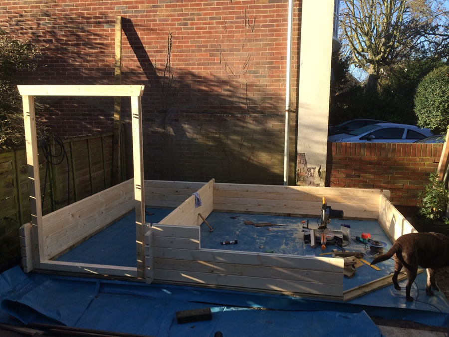 The build progresses with the shed door frame in place.
