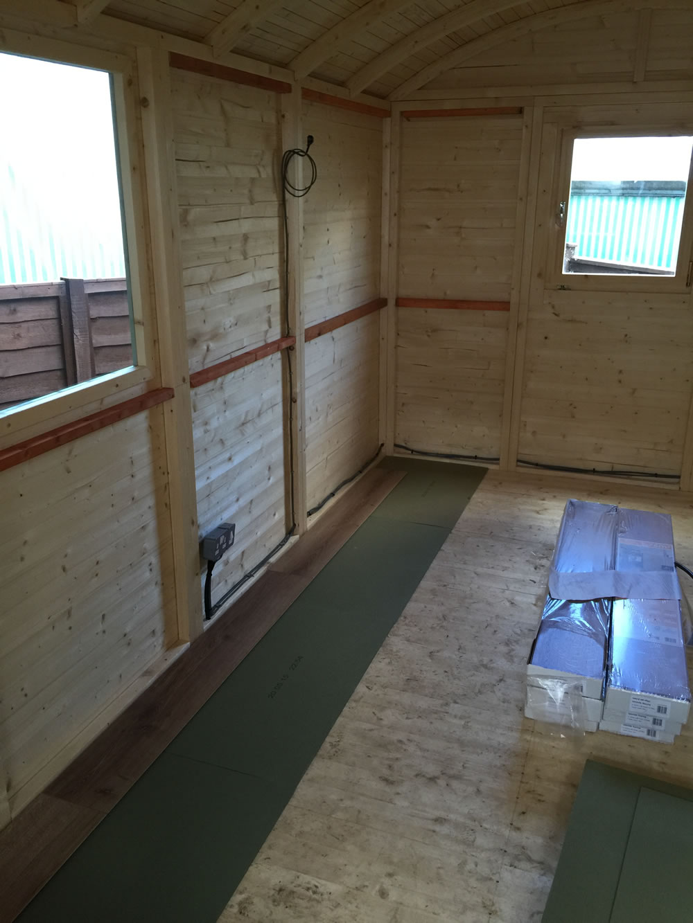 Additional battens in the walls and laminate flooring is installed. An electrical circuit is also now in place.