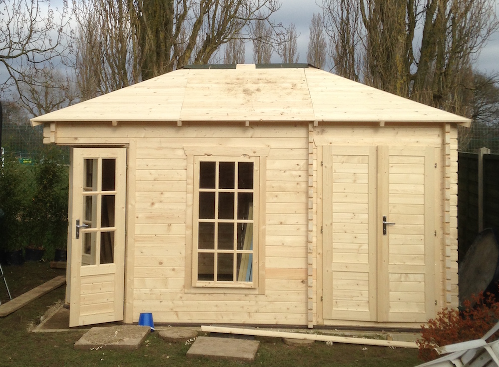 Roof structure and roof boards complete on a log cabin ready for the final roof covering to be applied.