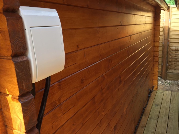Consumer units are fitted externally (IP65 rated). These small garage ones from Screwfix hide away nicely behind the log corners.