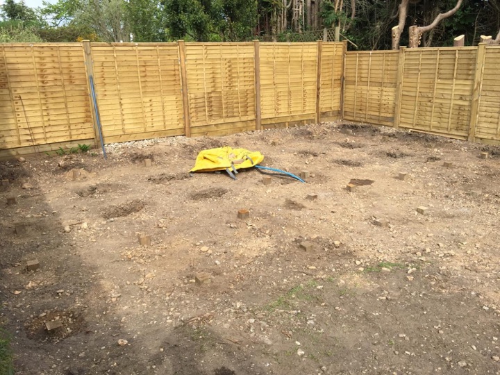 To support the wooden frame, holes were dug to take 4” tanalised posts set in postcrete. Whilst only 50mm-100mm is visible, each is about 600mm long