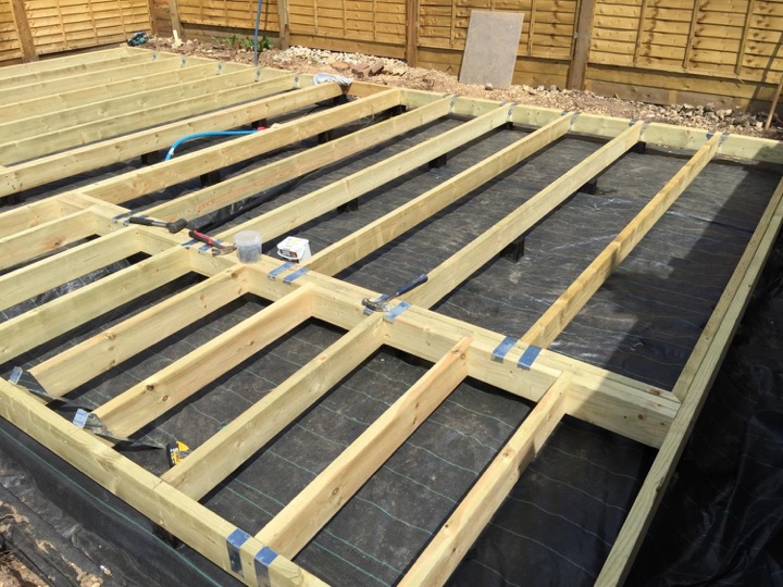 Joists installed with hangars. You could build a house on this frame, let alone a cabin!