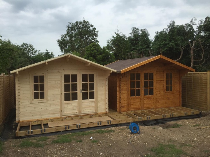 The Ulrik ‘twins’ log cabins. The wood is protected with 2 undercoats of Sikkens Cetol HLS plus and finished with a further 2 of Sikkens Filter 7 Plus in light oak.