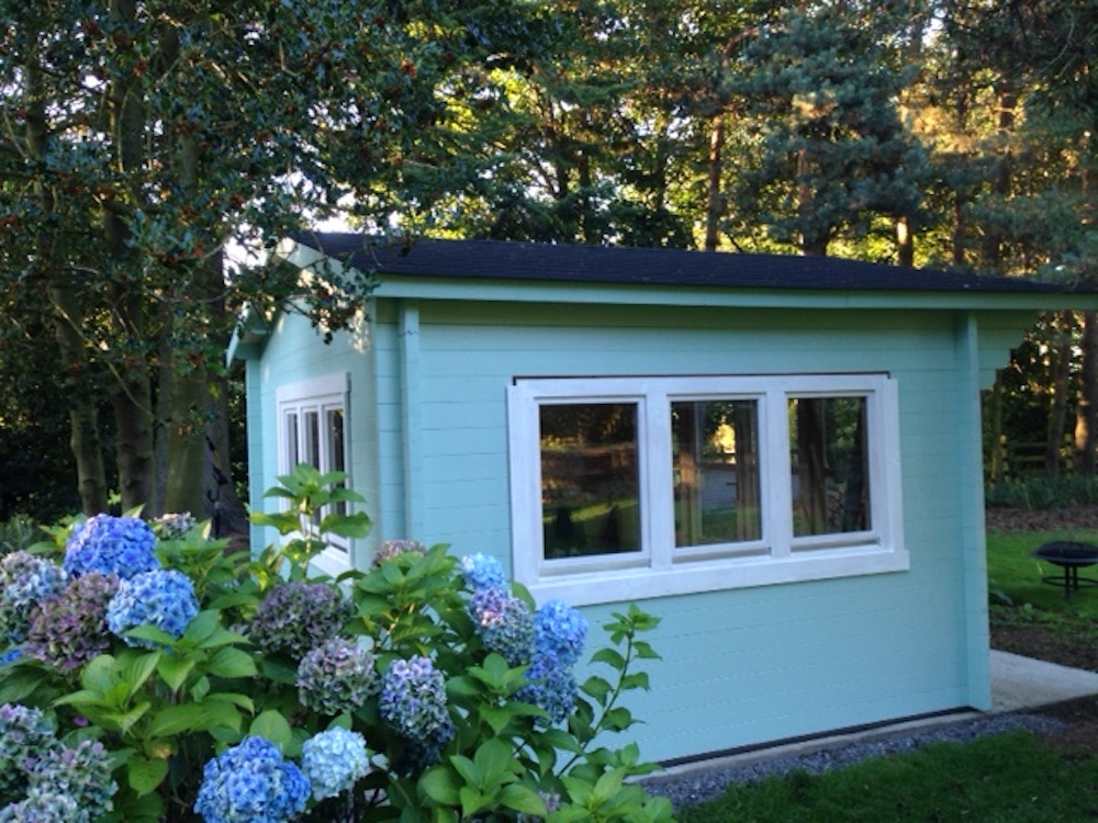 A Turquoise Painted Blackpool Log Cabin