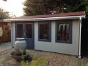 Aiste Log Cabin Painted With Carefree Protective Paint in Concrete Grey and Johnstone Paint in Dark Grey