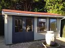 Aiste Log Cabin Painted With Carefree Protective Paint in Concrete Grey and Johnstone Paint in Dark Grey