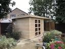 Delinger flat roof log cabin with side canopy