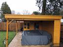 Annette corner log cabin with canopy, great for a hot tub or outdoor dining.