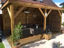 Grande Gazebo in a timber frame base with decking and their own wall